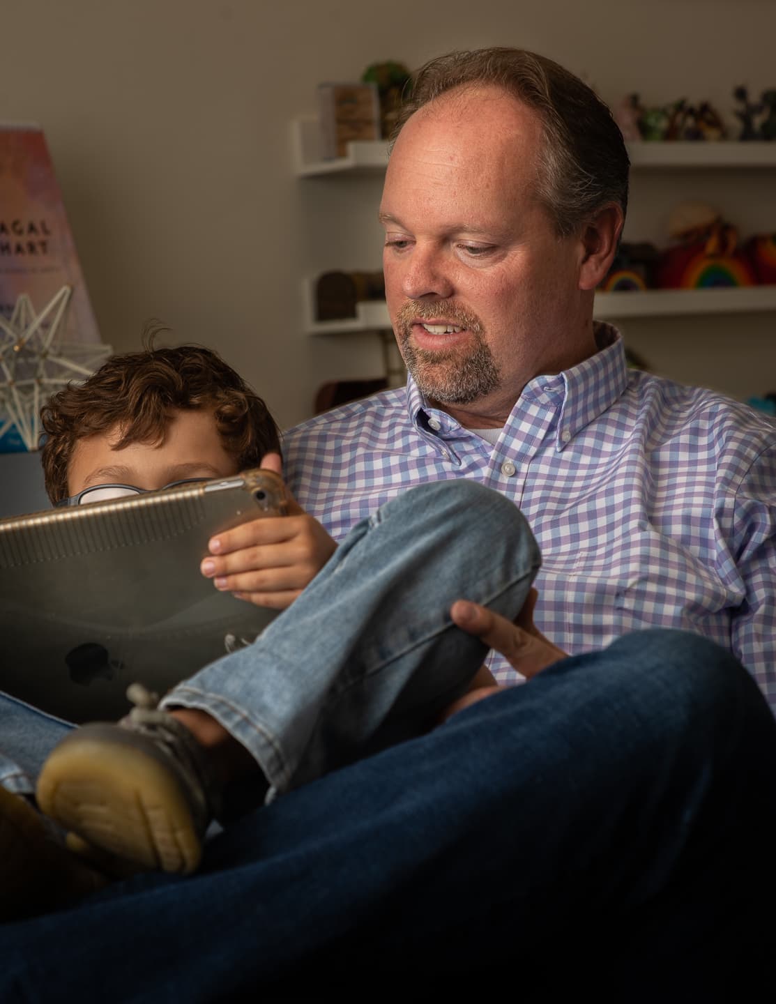 Jason Cheney sitting with a child during a session